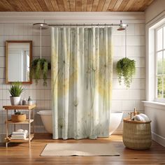 a bathroom with a shower curtain that has plants on it and a rug in front of the bathtub