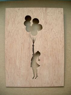 the silhouette of a person holding balloons is shown on a wooden plaque that reads, happy birthday