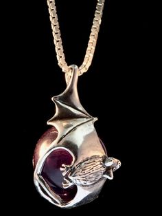 This magical, Night Flight Bat Orb is cast in sterling silver and wraps around a 20 mm gemstone sphere. The bat is 1-3/8 inches tall and 1 inch across. A chain slips through a bail on the bats upswept wing. Please select your desired orb in the dropdown options menu. You may choose between a Amethyst and Lapis Lazuli All Marty Magic Charms and Pendants include an 18 inch (46cm) box chain. If you would prefer a different length of chain please feel free to contact me. All Marty Magic Jewelry is p Gothic Gemstone Jewelry For Collectors, Gothic Collectible Gemstone Jewelry, Collectible Gothic Gemstone Jewelry, Hand Cast Fantasy Sterling Silver Jewelry, Hand Forged Fantasy Jewelry As A Gift, Fantasy Style Hand Forged Jewelry As Gift, Hand Forged Spiritual Jewelry For Formal Occasions, Silver Fantasy Jewelry For Formal Occasions, Gothic Purple Jewelry Gift