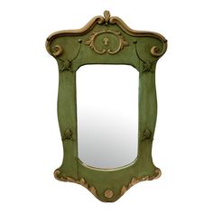 an ornate green mirror with gold trimmings on the edges and sides, against a white background