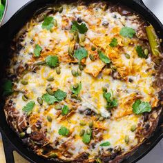 a casserole with cheese and vegetables in a black skillet