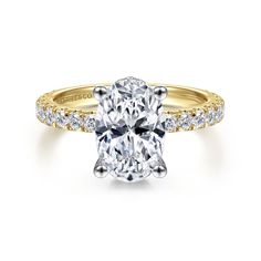 an oval cut diamond engagement ring with pave set shoulders