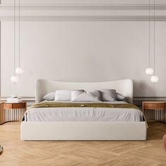 a large bed sitting on top of a wooden floor next to a white chair and table