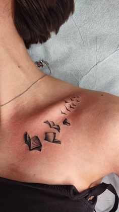 a woman with a book tattoo on her chest