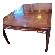 a wooden table with glass top and legs