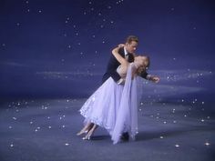 a man and woman dance together in the middle of an image with stars above them