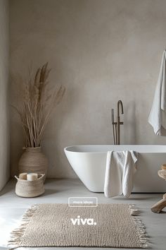 a white bath tub sitting on top of a bathroom floor next to a wooden stool