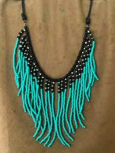 a blue and black beaded necklace with beads