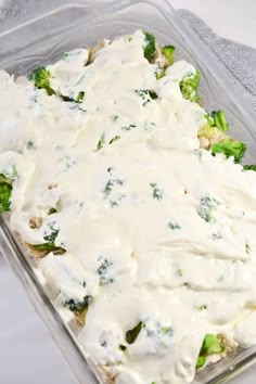 a casserole dish with broccoli and white sauce in it on a doily