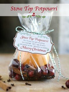 a bag filled with lots of food sitting on top of a wooden table next to cinnamon sticks