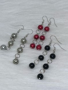 Hi Everyone, Cute earrings just for you, Handmade Earrings, Silver, Red, Black, Beads, Silver Dangle Earrings. Handmade fashion jewelry accessories perfect simple gifts for a special friend or mother daughter gifts. Can be for everyday look for women and her fashion accessory. The length is about 2.5 inches from top to bottom. You can choose different colors, Black, Red, Silver Beads. They are only $5.00 each. Pick your favorite color. Thank you for looking at my jewelry shop. Christmas Jewelry Diy, Diy Earrings Easy, Silver Wire Earrings, Beaded Earrings Diy, Easy Jewelry, Mother Daughter Gifts, Handmade Fashion Jewelry, Wire Work Jewelry, Silver Dangle Earrings