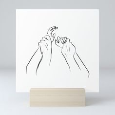 two hands reaching for each other on a white card