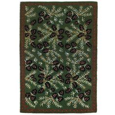 a green rug with pine cones and leaves on the bottom, in front of a white background