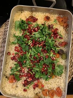 a white dish filled with rice and vegetables