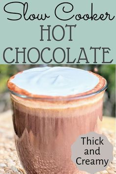 a close up of a cup of hot chocolate on a table with text overlay that reads slow cooker hot chocolate