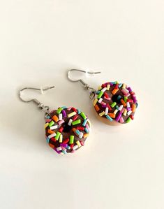 I love donuts so I made my favorite dessert into earrings! So come on now and order a pair of super cute donut earrings! Everyone will ask you about your earrings and you'll get lots of compliments, trust me I know!! This listing includes one pair of donut earrings with multicolored sprinkles handcrafted in polymer clay. Please allow for slight differences in the final product. It is very difficult to replicate each pair of earrings as these are handcrafted. Thank you for understanding. Question Donut Earrings, Earrings Food, Easter Earrings, Cute Donuts, Favorite Dessert, Food Earrings, Easter Peeps, Favorite Desserts, Jewelry Earrings Hoops