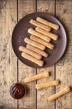 churros on a plate with dipping sauce and ketchup, top view