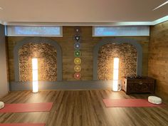 a yoga studio with wooden floors and stone arches