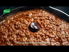 a close up of food in a pan with a spoon on the side and an advertisement above it