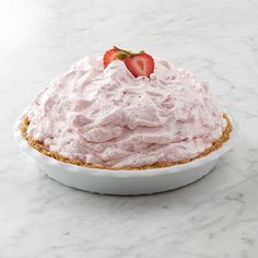 a white plate topped with a strawberry cream pie on top of a marble countertop