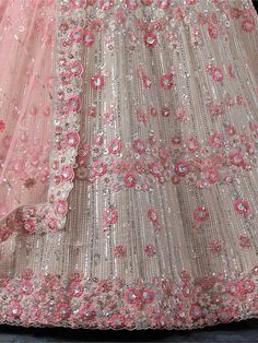 Turn heads at your next special occasion with our attractive white sequins net wedding lehenga choli with dupatta. This stunning outfit features intricate thread work, sequin work, and zarkan work on both the lehenga and choli, creating a dazzling and elegant look.
The pink net dupatta is also adorned with similar embellishments and beautiful lacework, adding a touch of femininity to the ensemble. The white color of this lehenga choli is versatile and classic, making it perfect for weddings, eng Luxury White Choli With Gota Work, Luxury White Choli With Dupatta, Lehenga Designs Latest, Happy Friendship Day Images, Wedding Lehenga Choli, Bridesmaid Lehenga, White Lehenga, Net Lehenga, Happy Friendship