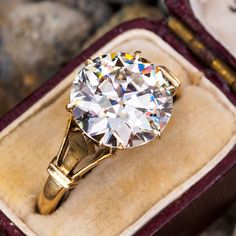 a diamond ring sitting in a velvet box