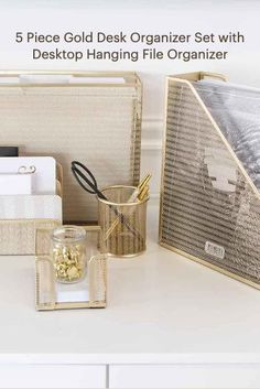 a white desk topped with lots of different types of office supplies on top of it