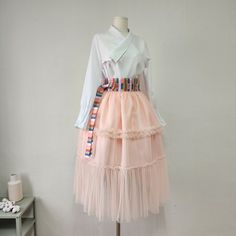 This is a Korean Modern Hanbok wrap style layered tulle see -through cover skirt for Women. This product is especially made with traditional Korean hanbok sewing techniques, so it is a sturdy skirt even after a long time. This hanbok is modernly designed so you can wear it comfortably and beautifully. This skirt, like a really luxurious piece of art, will make your special day even more beautiful. This modern hanbok is perfect dress for daily and celebrations such as parties or various events. ⭐ Layered Skirt For Spring Party, Fitted Organza Skirt For Spring, Spring Party Organza Skirt, White Wrap Skirt For Spring Party, Spring Sheer Skirt Dress, Spring Party Wrap Skirt, Tiered Style, Spring Party Tiered Wrap Skirt, Party Wrap Skirt With Ruffles, Spring Party Wrap Skirt With Ruffles