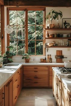 a kitchen filled with lots of wooden cabinets and counter top space next to a window