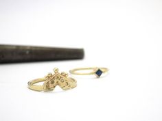 A beautiful set of 2 matching boho stacked 14k yellow gold rings, one of them with a blue sapphire.   This dazzling set consists of two rings:  One ring has a rhombus deep blue sapphire gem with one tiny gold dot on each side is set in a delicate gold ring, and on top of it sits another ring gold with a slightly thicker band and an ethnic ornamented crown-like design. The rings fit together perfectly and complement each other. Both rings are 14K yellow gold.  #bohoring #engagementrings #studioun Wedding Ring Ruby, Gold Gemstone Rings, Boho Rings Gold, Delicate Gold Ring, Sapphire Gem, Indian Rings