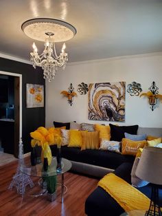 a living room filled with lots of furniture and yellow pillows on top of it's couches