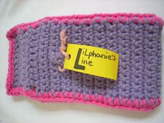 a crocheted purple and pink purse with a yellow sticker on it that says lippine's line