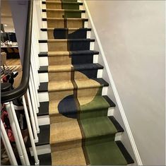 the carpeted stairs are painted with different colors