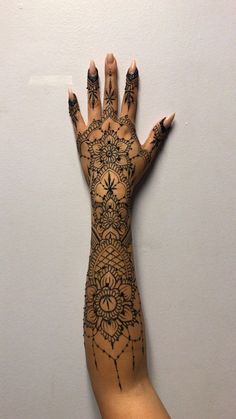 a woman's hand with tattoos on it