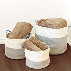 three baskets with towels in them sitting on the floor next to a wall that says small medium large 3 basket set