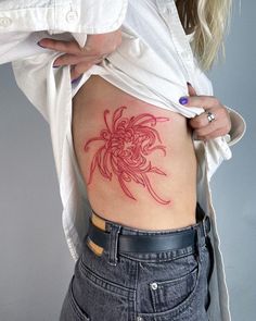 a woman with a tattoo on her stomach is holding onto the back of her body