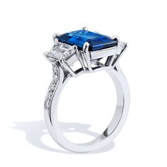 a blue and white diamond ring on a white background with the center stone surrounded by diamonds