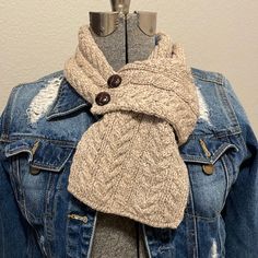 a denim jacket with a scarf on top of it