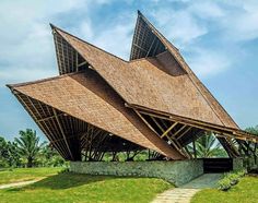 the building is made out of bamboo and has two large triangular shaped windows on each side