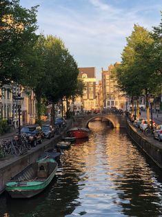 boats are parked along the side of a canal