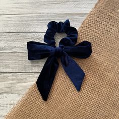 The midnight blue velvet bow hair tie features a deep, rich color and includes a detachable band for effortless bow styling.  This elegant accessory adds a touch of sophistication to any hairstyle, making it ideal for both casual and formal occasions.  The luxurious velvet texture not only looks chic but also ensures a secure hold, enhancing your overall look. Velvet Hair Bows, Velvet Hair Scrunchies, Navy Blue Scrunchie, Bow Hair Tie, Velvet Hair Bow, Adjustable Blue Satin Bow, Dark Blue Scrunchie, Christmas Hair Accessories, Tie Hair