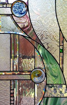 a stained glass window with different colors and designs on it's sides, including swirls