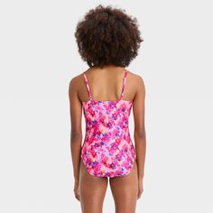 Add a creative touch of blooms to your kiddo's swimwear with this 'Painted Garden' Floral Printed One-Piece Swimsuit from art class™. The monokini-style sleeveless swimsuit features an attractive print of painted florals on a pink backdrop, and has front cutouts with knotted details for added style. Made from stretchy opaque fabric, this pull-on swimsuit offers flexible comfort and coverage both in and out of the water. The adjustable over-the-shoulder straps lend a customized fit, and the UPF 5 Playful Printed Tankini For Swimming, Playful Pink Printed Swimwear, Spring Playful Tankini For Swimming, Playful Fitted Swimwear With Floral Print, Fitted Playful Floral Print Swimwear, Playful Fitted Floral Print Swimwear, Playful Spring Tankini, Floral Print Swimwear For Spring Playwear, Playful Printed Tankini For Poolside