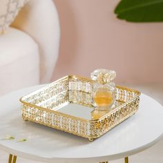 a white table with a gold tray on it