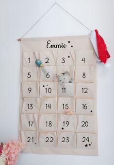 a calendar hanging on the wall with a santa hat