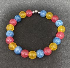 Genuine jade and aquamarine beads come together to create the Pansexual Pride flag. Beads are 8mm. Bracelet is 6 inches around and made with crystal stretch elastic cord. Pansexual Bracelet, Make Clay Beads, Flag Beads, Pansexual Pride, Purple Jade, Aquamarine Beads, Pride Flag, Butterfly Charm, Pride Flags