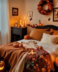 a bedroom decorated for halloween with pumpkins and candles