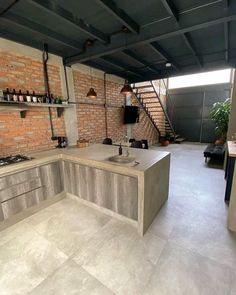 an industrial kitchen with brick walls and flooring is pictured in this image, the counter tops are made out of concrete