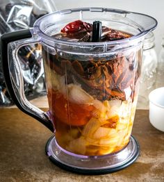 a blender filled with food sitting on top of a table