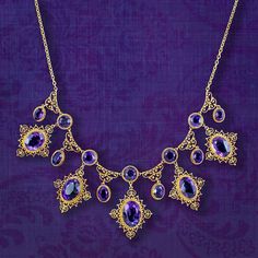 A majestic antique Victorian necklace featuring a fabulous gallery consisting of eleven droppers and sixteen deep purple amethysts that range from approx. 0.80ct to 6ct (approx. 32ct total). Each stone is bezel set with a rope edge and surrounded by beautiful, scrolling cannetille metalwork all fashioned in 18ct gold.  Amethyst is the birthstone of February and is considered a stone of protection, clarity and tranquillity. Its deep violet colouring has been highly esteemed throughout history, ad British Crown Jewels, Victorian Jewellery, Edwardian Engagement Ring, Antique Jewellery Online, Victorian Necklace, Crown Jewels, Victorian Jewelry, Amethyst Necklace, Memento Mori